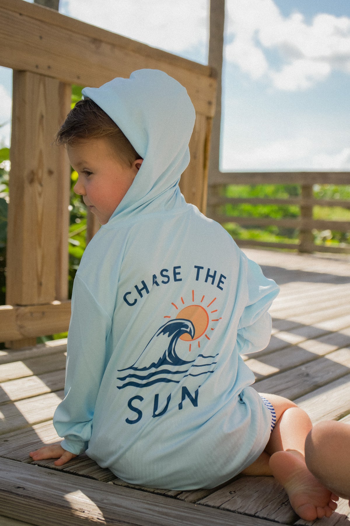 Lifestyle photo of the Youth Sun SRQutie SPF Hooded Tee