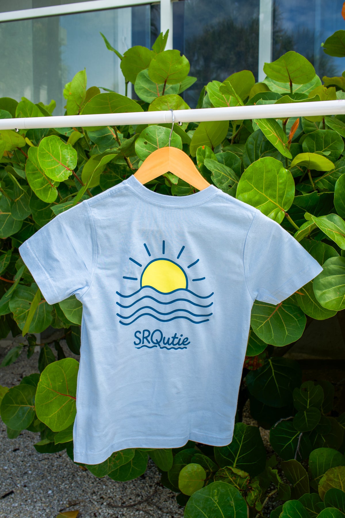 Back view of the Youth Sunset SRQutie Tee in Light Blue
