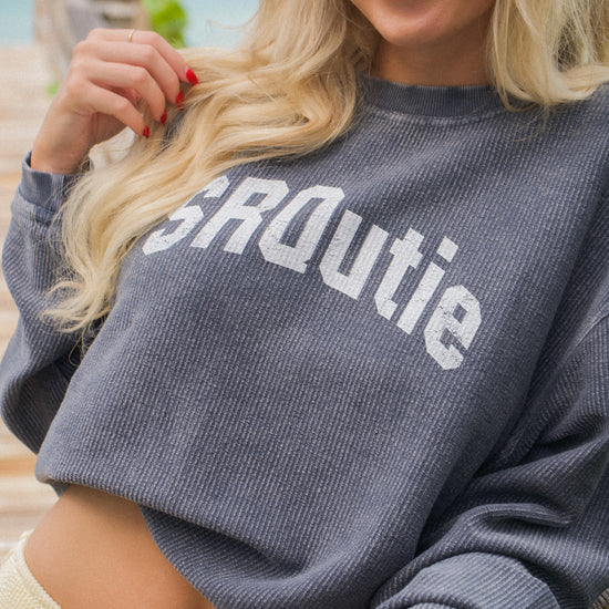 Lifestyle photo of the women's SRQutie Ribbed Varsity Sweatshirt