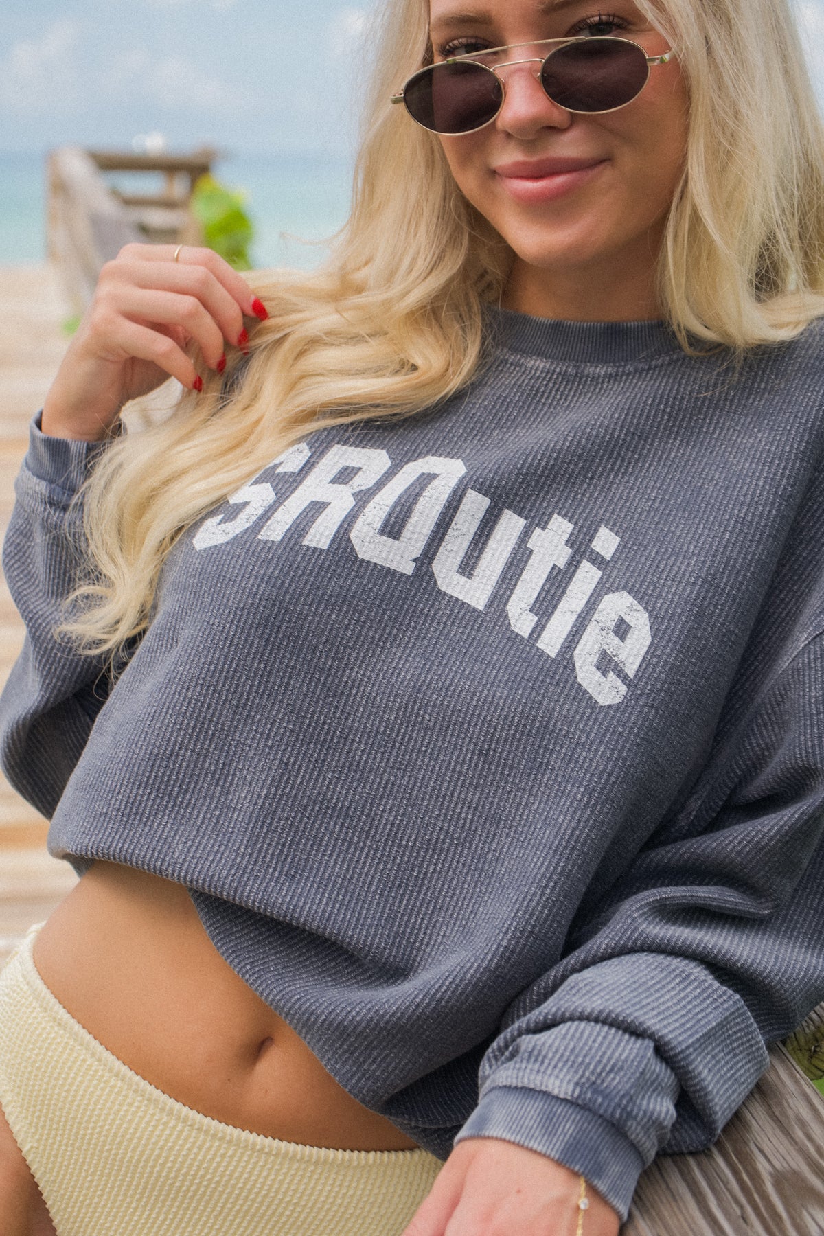 Lifestyle photo of the women's SRQutie Ribbed Varsity Sweatshirt