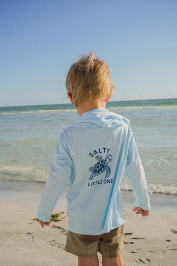 Lifestyle photo of the Toddler Salty SRQutie SPF Hooded Tee